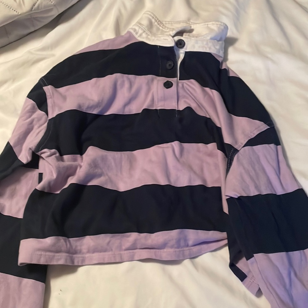 White collar, black and purple striped, long sleeved, sorta cropped shirt.